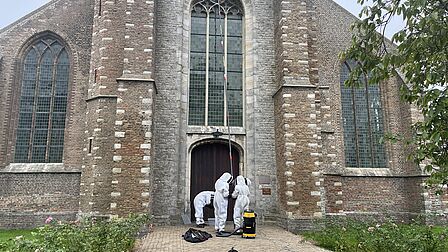 Vrijwilligers verwijderen nest bij de kerk